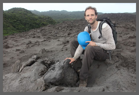 Richard Roscoe at Yasur Volcano next to a recent volcanic bomb